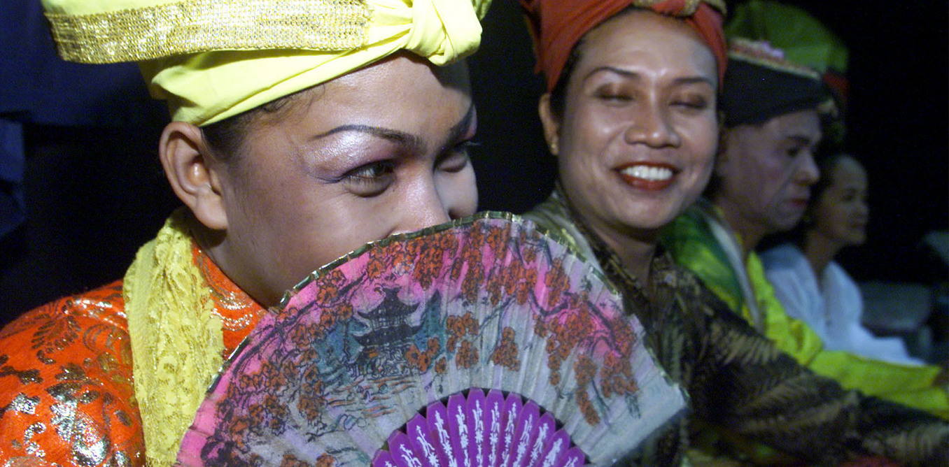 BISSU MEMBERS LISTEN TO THEIR DIRECTOR BEFORE A THEATRICAL PERFORMANCE IN JAKARTA.