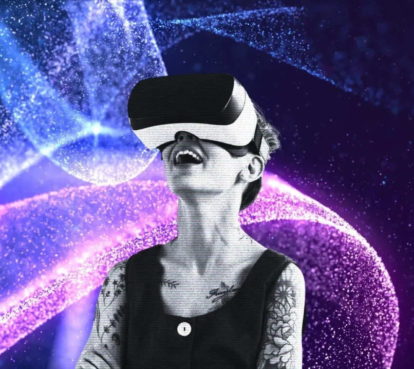 Persona con visor de realidad virtual rodeada de luces digitales en tonos azul, púrpura y rosa.