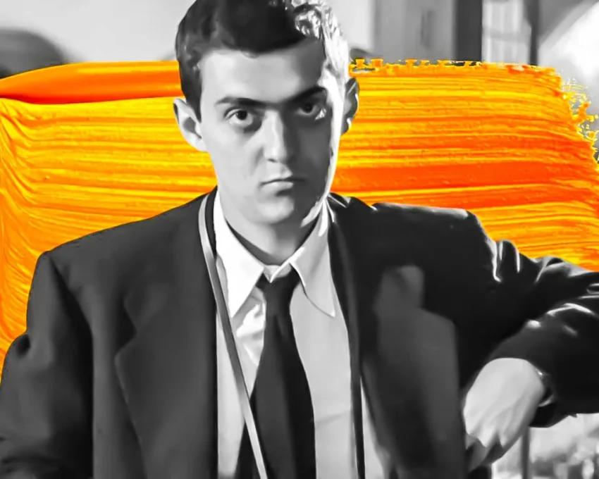 Retrato artístico en blanco y negro de un joven con fondo naranja vibrante