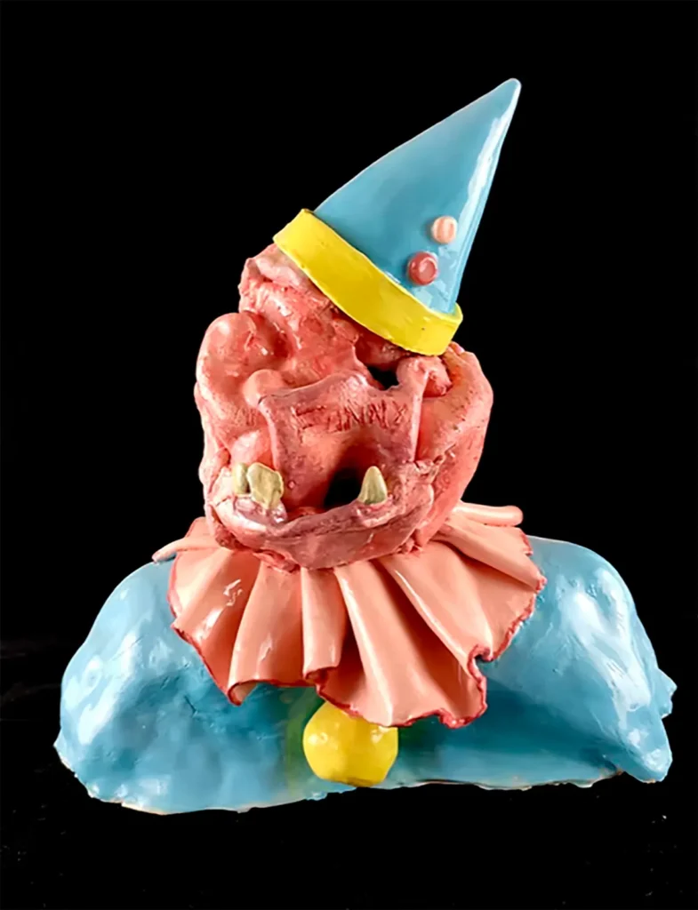 Las piezas de cerámica de Miguel B., a menudo cubiertas con silicona rosa que simula chicle, funcionan como superficies en las que lo artesanal se mezcla con lo irónico, generando un imaginario tan lúdico como inquietante.